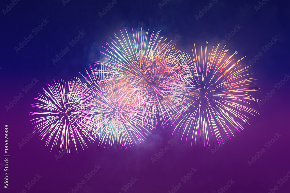 Colored fireworks on the dark blue sky background