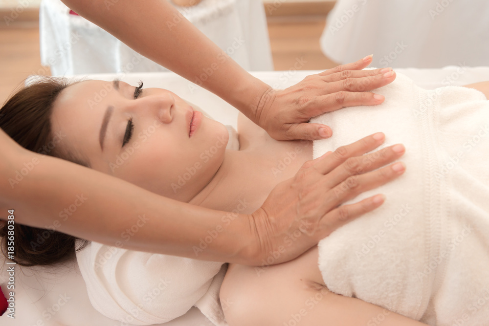 Asian exotic holiday spa concept. Beautiful young chinese woman enjoy relaxing during massage at spa, taken indoor in real spa location. Asian exotic holiday spa concept. Beautiful young chinese woman enjoy relaxing during massage at spa, taken indoor in real spa location.