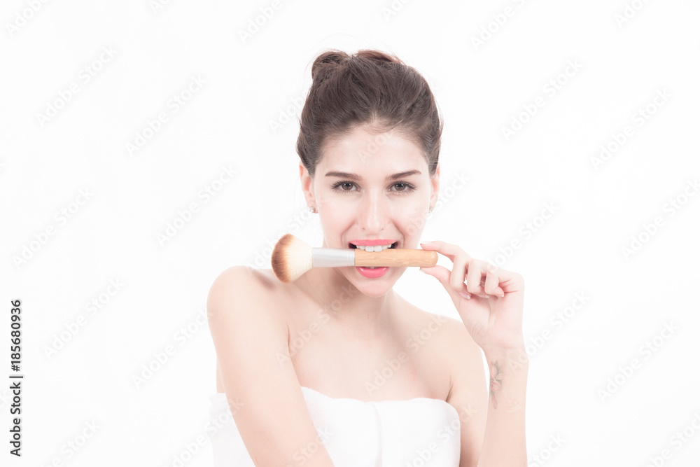 Woman beauty concept. Beautiful white woman wrapped in white towel isolated in white holding a make up brush. Beauty concept. Woman beauty concept. Beautiful white woman wrapped in white towel isolated in white holding a make up brush. Beauty concept.