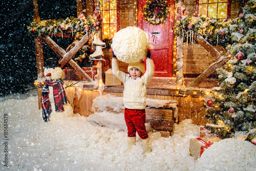 child holds big snowball