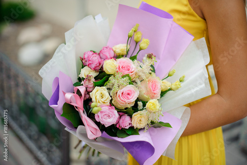 Wallpaper Mural woman holds bouquet of roses packed in white and purple wrapping-paper Torontodigital.ca