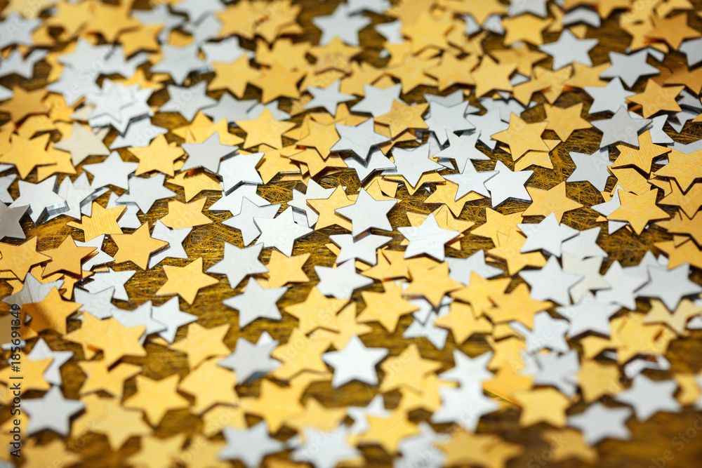 Asterisks shiny Christmas scattered on a gold background Asterisks shiny Christmas scattered on a gold background