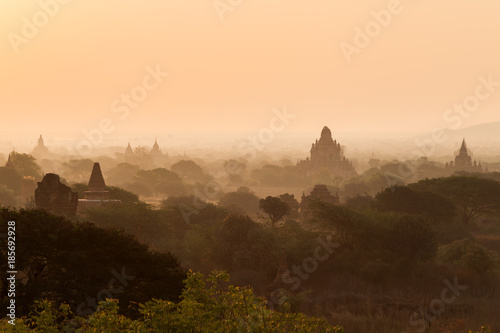 Silhouette of many pagodas and temples at misty plain in Bagan  Myanmar  Burma  in the morning  viewed slightly from above.