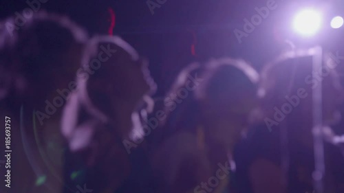 Out of focus youthful young teenage crowd dancing at a concert party STock footage