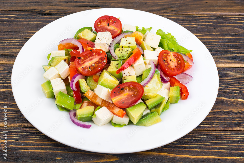 Dietary salad of fresh vegetables with avocado and goat cheese