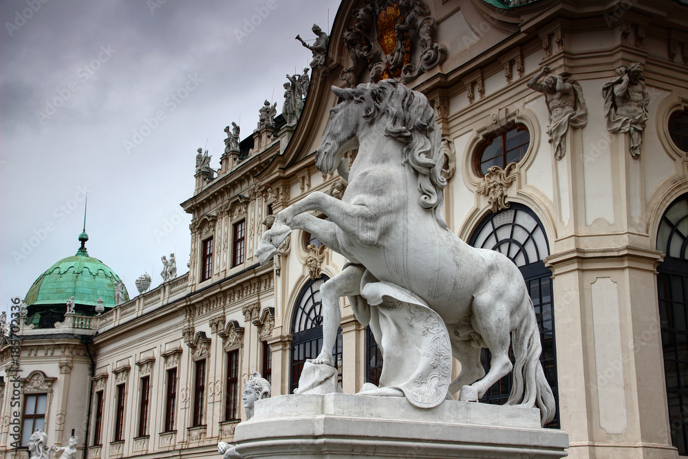 Equine statue of white horse rearing on its hind legs in front of facade of Baroque style Upper Belvedere Palace former residence for Prince Eugene of Savoy, Vienna, capital city of Austria, Europe