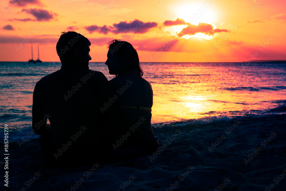 Young Couple Enjoying Sunset By The Beach