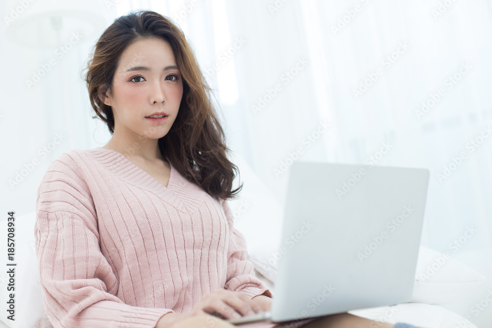 Attractive female using laptop at bedroom. People lifestyle concept. Attractive female using laptop at bedroom. People lifestyle concept.