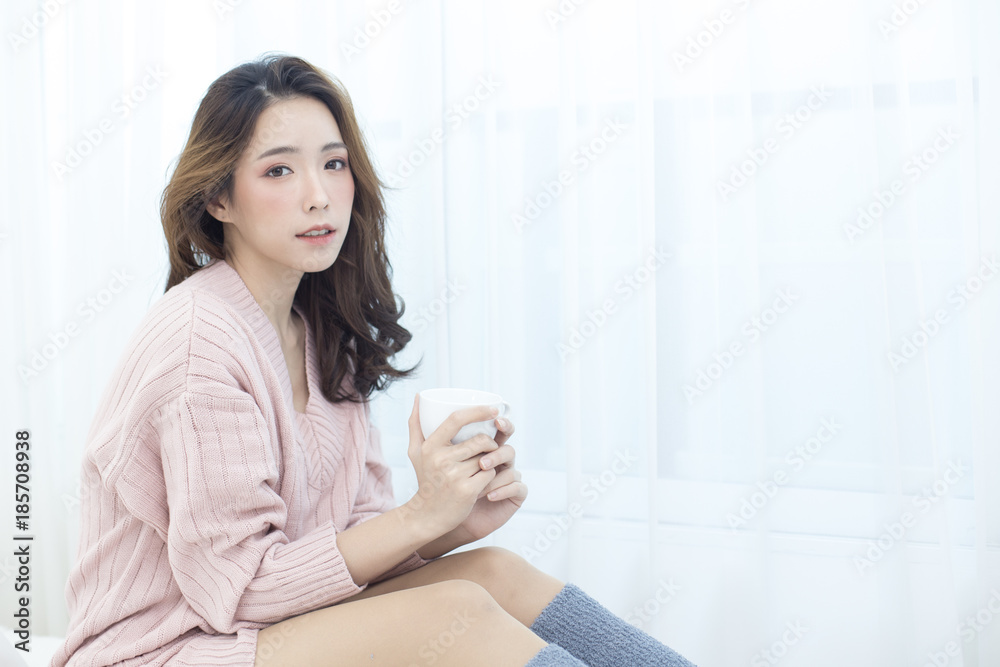 Asian Woman holding coffee cup at bedroom. People lifestyle concept.