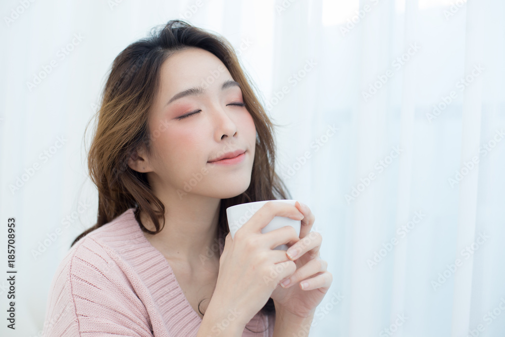 Asian Woman holding coffee cup at bedroom. People lifestyle concept. Asian Woman holding coffee cup at bedroom. People lifestyle concept.