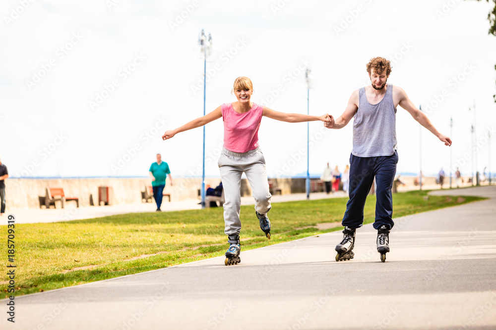 Active people friends rollerskating outdoor.