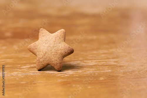 Gingerbread Cookie. Shape star. Brown background