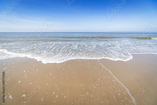 Fototapeta Naklejka Na Ścianę i Meble -  Beach with small waves coming in on the shore