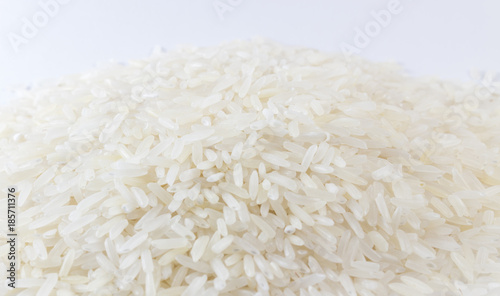 Close up raw grain on white background. A pile of raw rice.