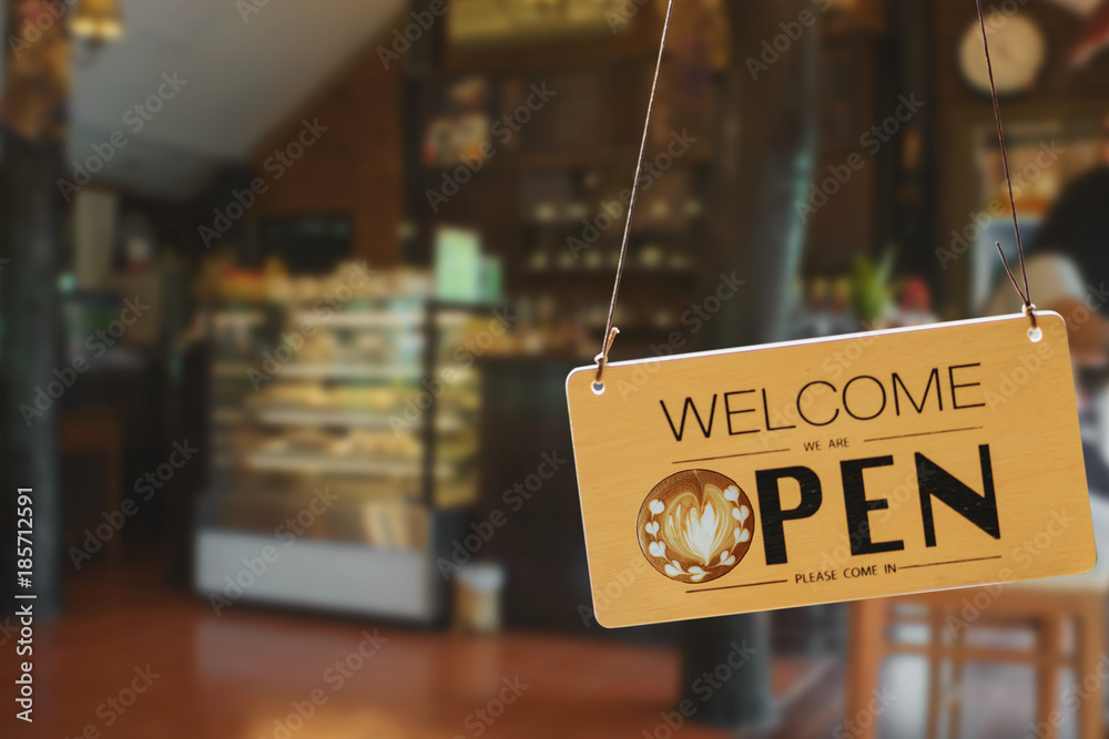 Wooden sign board hanging on door of cafe