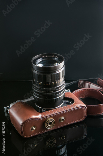 photo camera on black background. hipster paradise. lifestyle of creative people. mirrorless equipment. free space concept