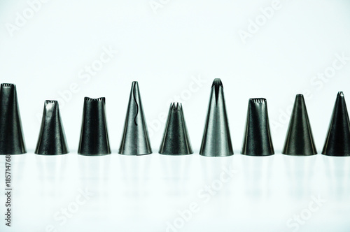 Sets of cream piping nozzles made from stainless steel isolated on white background. It is used to decorate cakes using cream. 