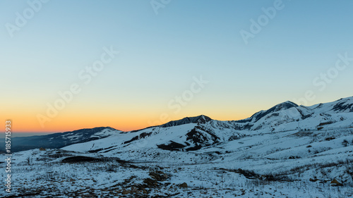 Last rays of sun on a snowly mountain peak © Vastram