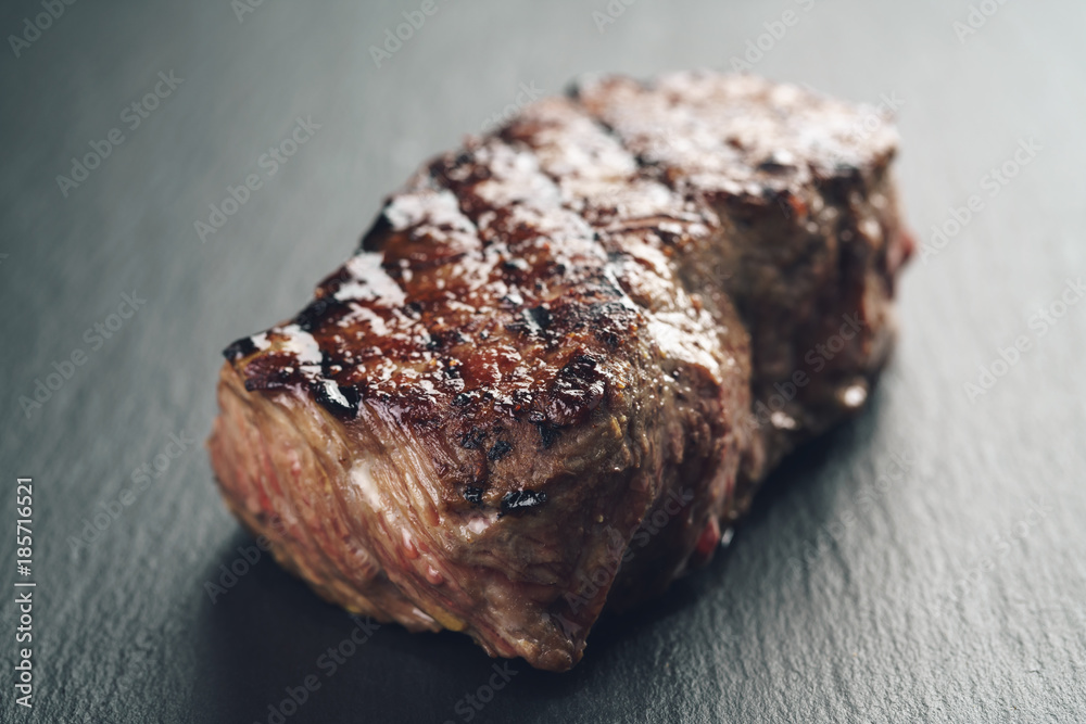 prepared beef steack on slate board closeup prepared beef steack on slate board closeup