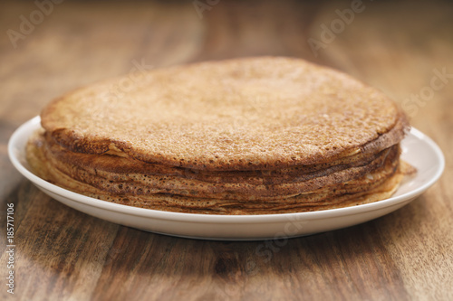 homemade crepes on plate on wood table