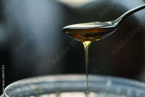 organic honey dripping from spoon