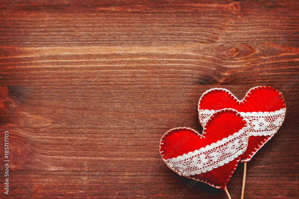 Two felt hearts with laces, symbol of love, on wooden background. Good for Valentine's Day cards. Place for text. Two felt hearts with laces, symbol of love, on wooden background. Good for Valentine's Day cards. Place for text.