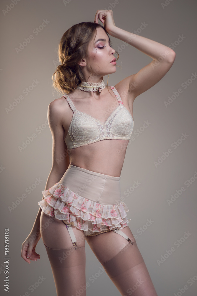 Lady in white vintage retro lingerie posing at camera foto de Stock | Adobe  Stock