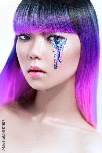 Portrait of purple hair asian woman with pixel tears over white background