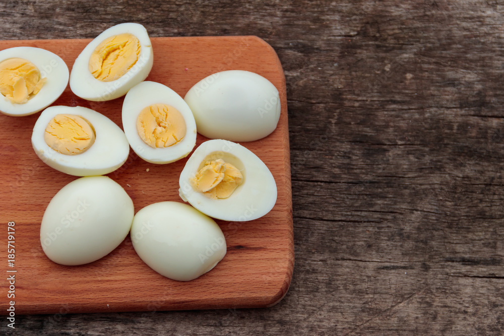 Boiled eggs on cutting board on wooden table Boiled eggs on cutting board on wooden table