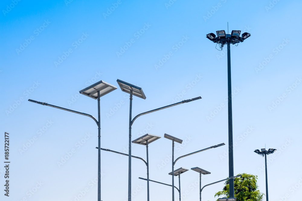 LED street light with solar cell, electric spot light in blue sky background. Green energy concept.
