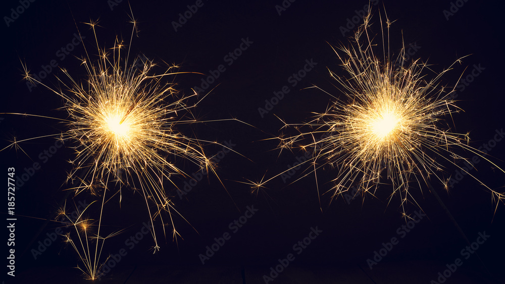 Christmas sparklers on a dark background. Copy of space.