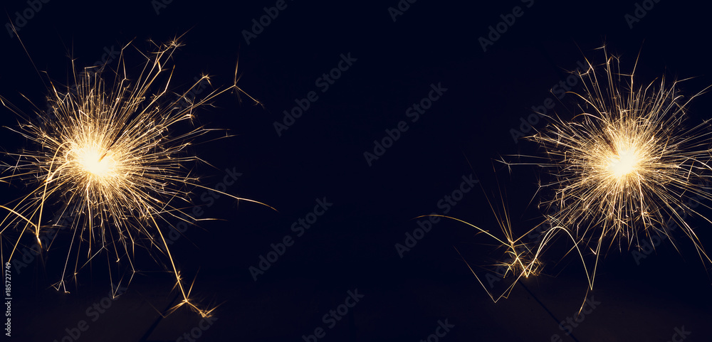 Christmas sparklers on a dark background. Copy of space.