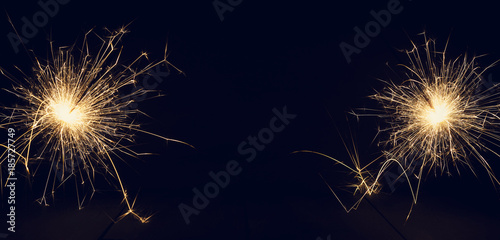 Christmas sparklers on a dark background. Copy of space.