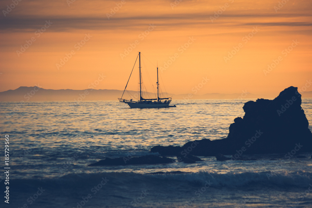 Silhouette of sailboat at sunset