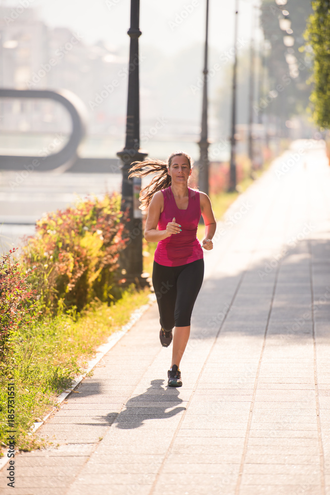woman jogging at sunny morning