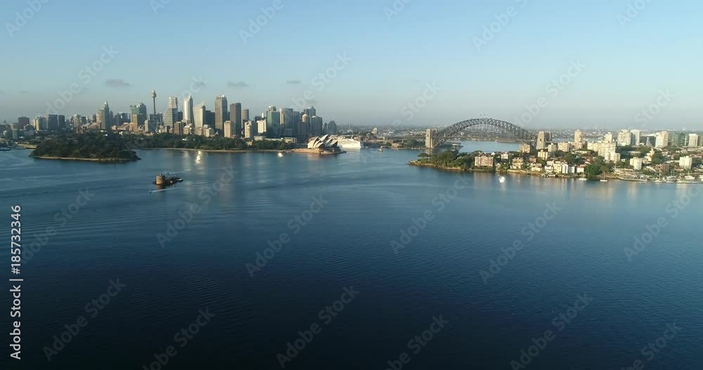 Slow descending overlooking Sydney city CBD landmarks and waters of Harbour off Lowe North shore suburbs on clear quiet morning.
Slow descending overlooking Sydney city CBD landmarks and waters of Harbour off Lowe North shore suburbs on clear quiet morning.
