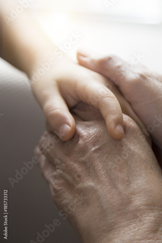 The mother is holding the hand of the baby. Mother's and baby's hands. Family concept 