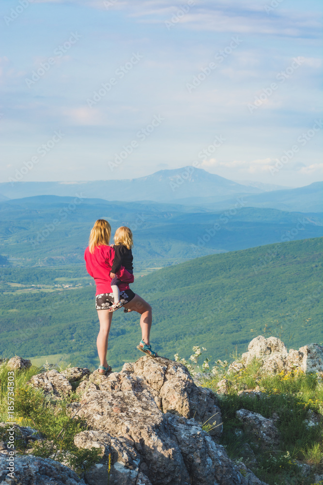 Mother with her daughter standing on cliff Mother with her daughter standing on cliff