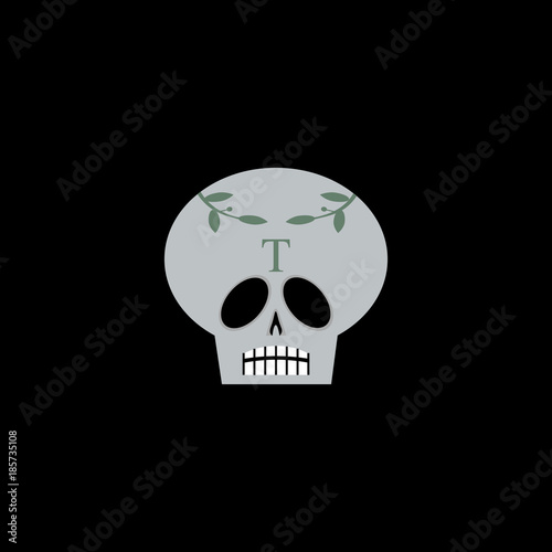 Ornate skull with laurel leaves and letter T.