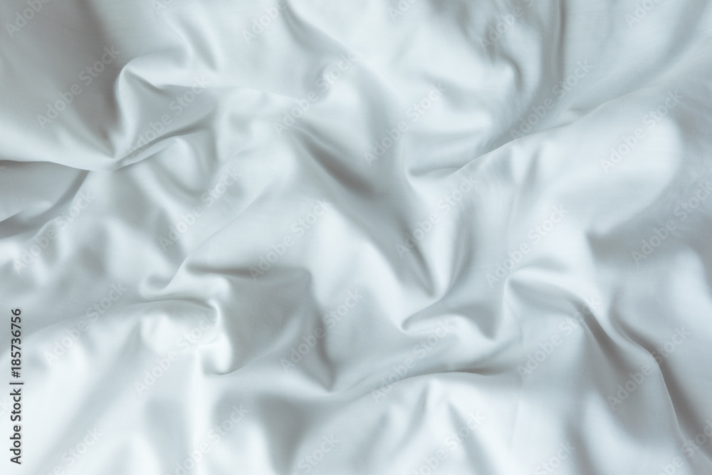 Top view of white bedding sheets after wake up in the morning
