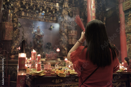 People praying and wishing a happy chinese new year, vihara satya dharma, bali, indonesia photo