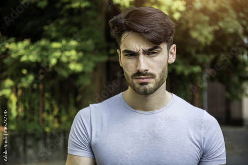 Handsome young man outdoor looking at camera