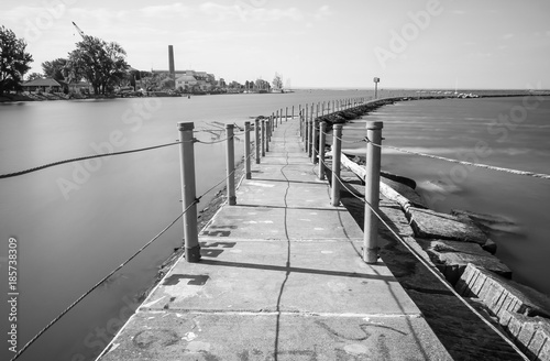 Exterior daytime black and white long exposure stock photo of concrete trail on Bird Island Pier in Niagara River adjacent to Lake Erie in Buffalo New York photo