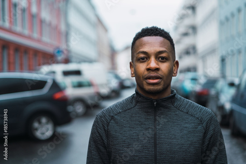 Portrait of young man standing on street photo