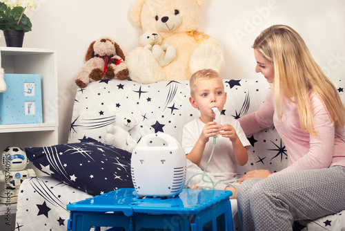 Wallpaper Mural Young woman with son doing inhalation with a nebulizer at home. Mother of a young child making inhalation Torontodigital.ca