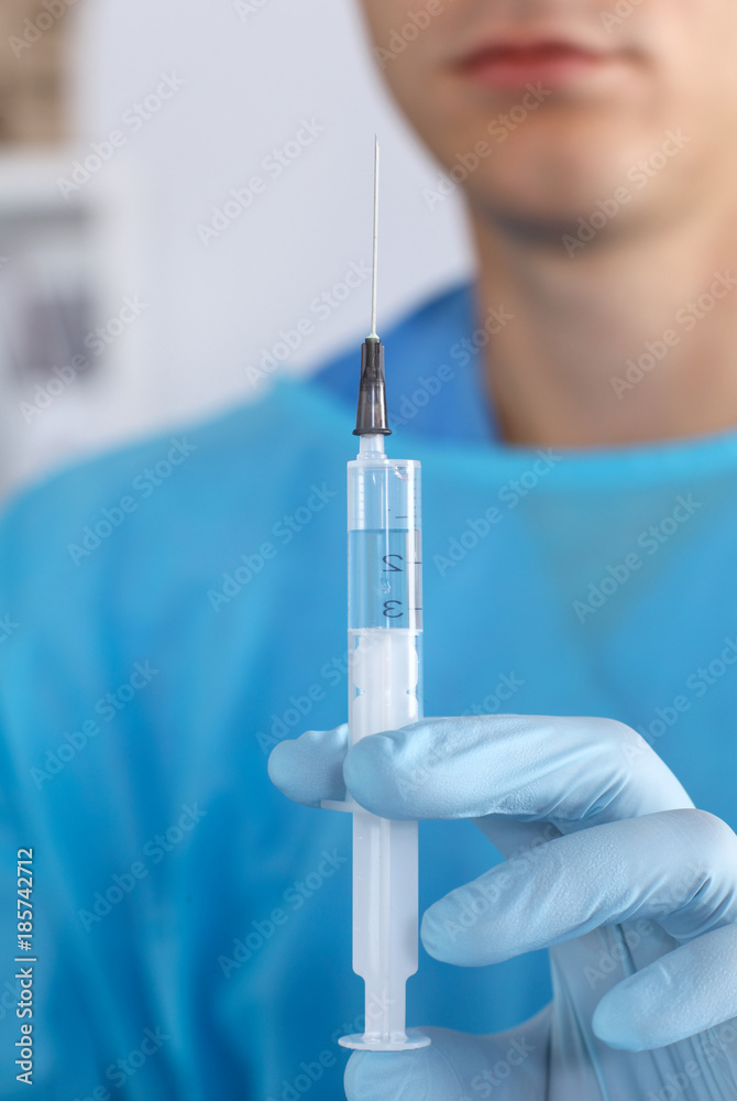 Young Doctor syringe with in his hand Young Doctor syringe with in his hand