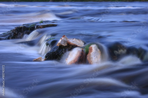 water flow on long exposure. small waterfall on mountain river stream. river rapids close up.