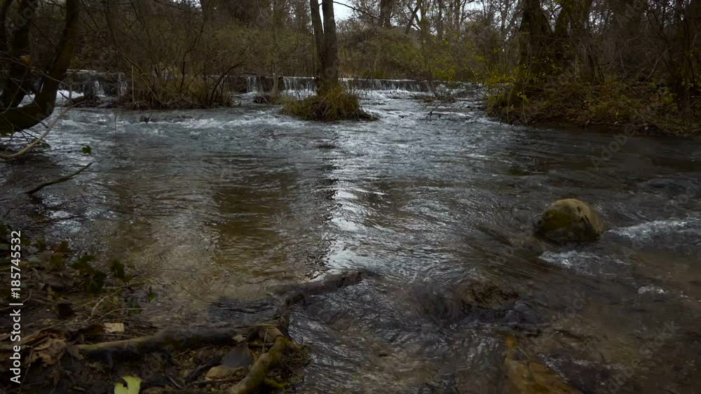 The river flows through the forest channel. Rapid movement of the river in the wild. The river flows through the forest channel. Rapid movement of the river in the wild.