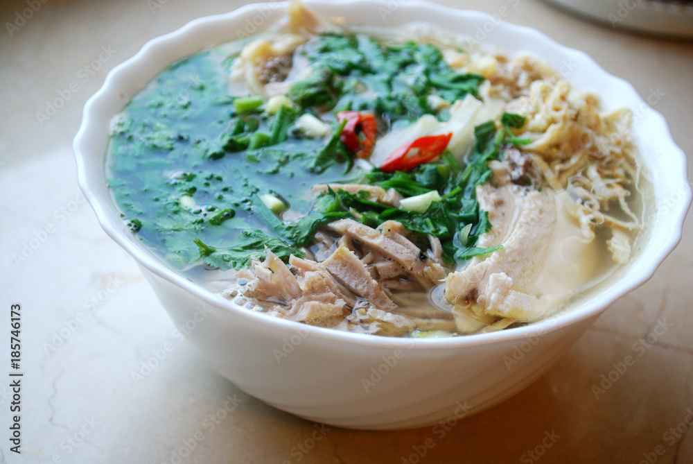 Bun Thang - traditional vietnamese rice noodles with shredded chicken, ham and eggs which is garnished by chopped cilantro, spring onion and chili slices. Bun Thang - traditional vietnamese rice noodles with shredded chicken, ham and eggs which is garnished by chopped cilantro, spring onion and chili slices.