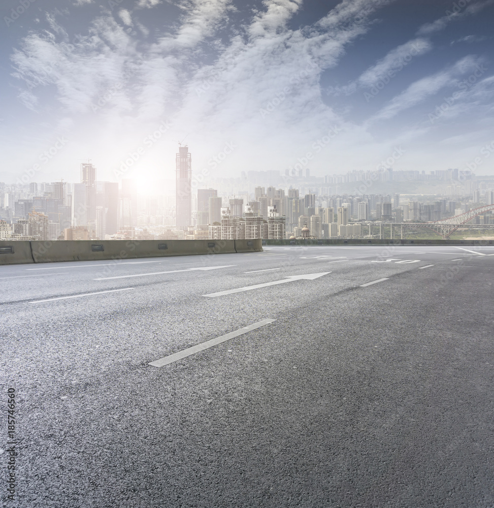 Road pavement and city skyline Road pavement and city skyline